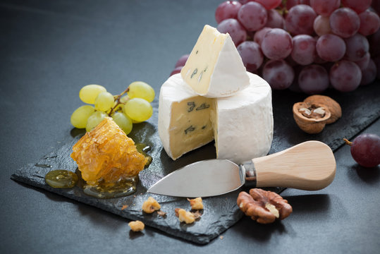 delicious Camembert with fresh honey, grapes and nuts 
