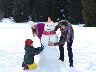 happy family making snowman
