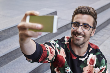 Young man taking selfie with Smartphone