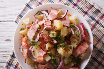 Potato salad with bacon and onions in  close up. horizontal top view
