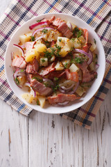 Potato salad with bacon and onions. vertical top view

