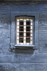 Fototapeta na wymiar Barred window on an old brick building