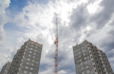 Fototapeta premium House construction and construction cranes
