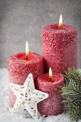 Three red candles on gray background, Christmas decoration. Adve