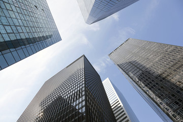 Fototapeta na wymiar looking uop to modern glass and steel office buildings in lower