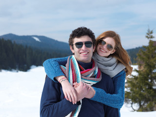 happy young couple having fun on fresh show on winter vacation