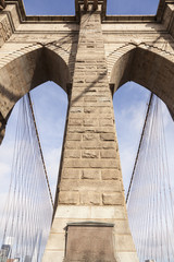 closeup of tower and cables of brooklyn bridge in new york
