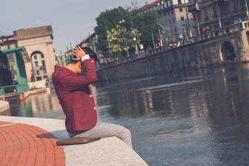 Handsome Asian model sitting by an artificial basin