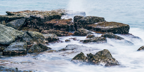 Rocks and waves at Point Cartwright beach in the afternoon. Sunshine Coast, Queensland.
