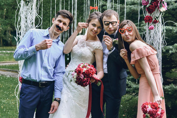 elegant stylish happy guests and bride and groom having funny ph