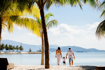 unidentified family vacation on luxury beach resort in tropics
