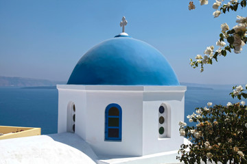 Fototapeta na wymiar White orthodox church with blue dome, Santorini island, Greece.