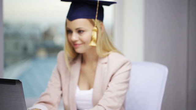 student girl in bachelor cap showing diploma