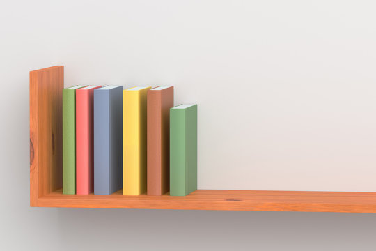 Colored books on wooden bookshelf on white wall