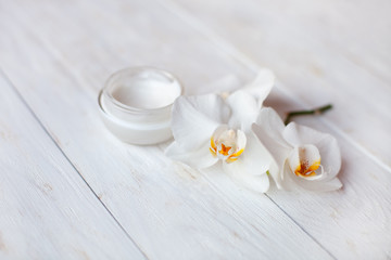 Fototapeta na wymiar pot of moisturizing face cream on white wooden table