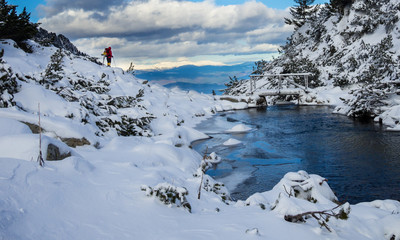 Winter landscape -  Small river and wooden bridge in high winter mountain, Bulgaria.