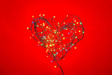 Heart shaped Christmas lights on red