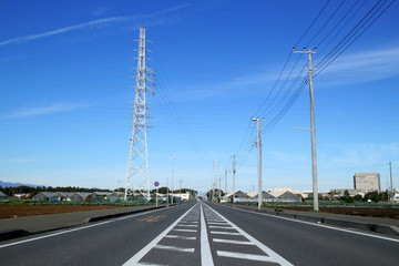 steel tower and straight road in the blue sky