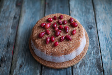 curd cake with chocolate chips and berries on old wooden table