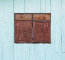Obraz na płótnie Canvas old wood window on blue wooden wall