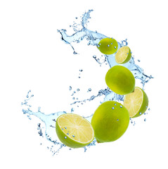 Fresh fruits, lime falling in water splash, isolated on white background