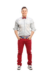Young fashionable man posing in red jeans
