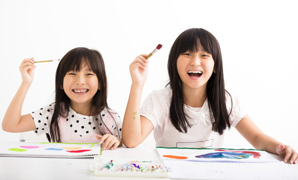 happy children painting in the classroom