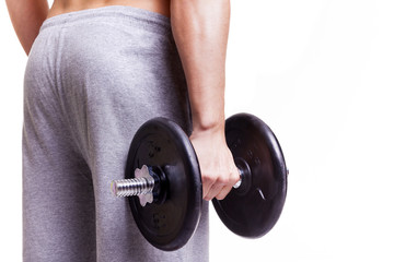 Fit man holding a dumbbell, isolated over a white background