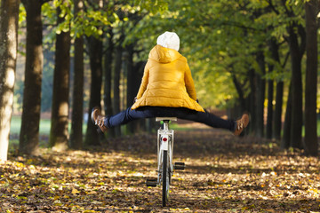 Happy girl riding a bicycle at the park