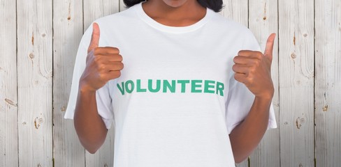 Woman wearing volunteer tshirt and showing thumbs