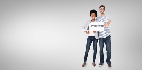 Happy couple holding a volunteer sign