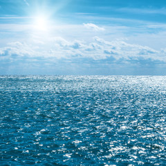 Blue sea with sky and clouds