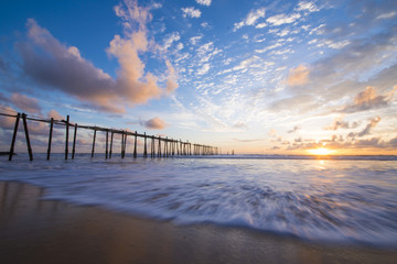 old wooden bridge in Natai beach with beautiful sky at twilight