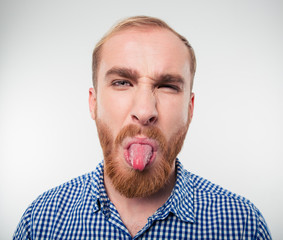 Portrait of a casual man showing his tongue