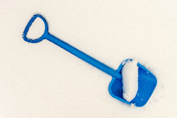 Blue Plastic Shovel in Snow