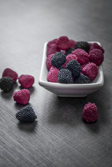 colorful jelly candies in bowl on wooden table
