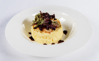 Mashed potatoes with slices of fish and salad