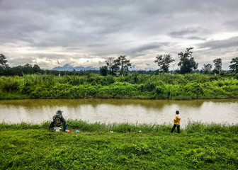 Fototapeta na wymiar Fishing by the creek