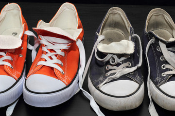 new orange and old blue sneakers - obrazy, fototapety, plakaty
