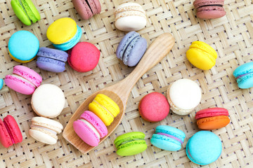 Colourful macaroon with wooden spoon for background