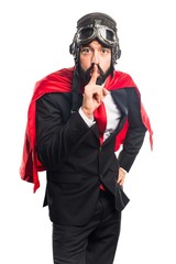 Super hero businessman making silence gesture