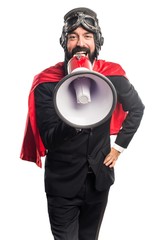 Super hero businessman shouting by megaphone