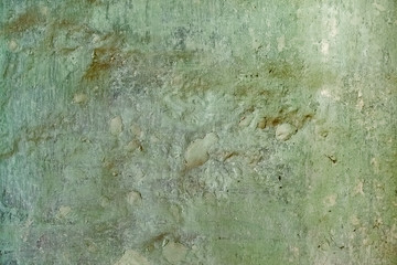 Old plastered surface yellow and green