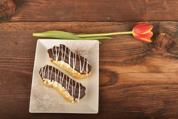 Tasty chocolate eclair and cream