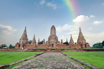 Fototapeta premium Old buddha pagoda temple with cloudy sky and rainbow in Ayuthaya Thailand