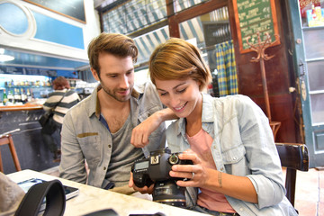 Team of photographers checking shots on digital tablet