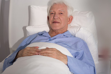 Elderly patient in bed - obrazy, fototapety, plakaty