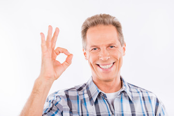 Confident happy aged man gesturing ok