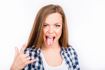 Funny girl showing her tongue and gesture rock end roll
