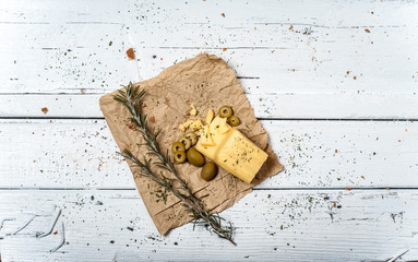 Cheese and olives on the white wooden retro table